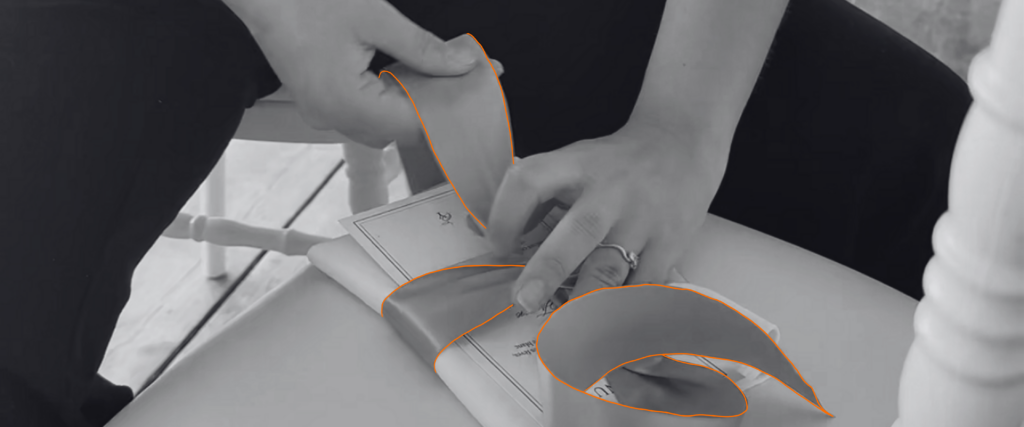 Alexia et Louis, wedding planners chez Hyppa Events, réalisent les derniers nœuds de serviettes sur les tables de réception avant l'arrivée des invités.
